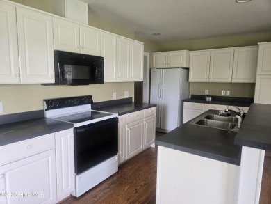 This charming farmhouse-style home with wraparound porches on Ocean Ridge Plantation in North Carolina - for sale on GolfHomes.com, golf home, golf lot