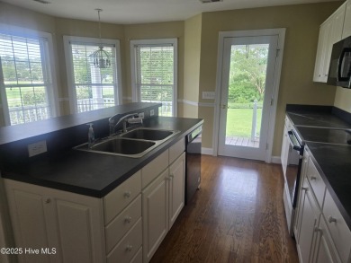 This charming farmhouse-style home with wraparound porches on Ocean Ridge Plantation in North Carolina - for sale on GolfHomes.com, golf home, golf lot