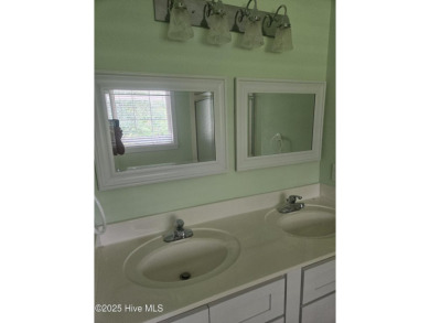 This charming farmhouse-style home with wraparound porches on Ocean Ridge Plantation in North Carolina - for sale on GolfHomes.com, golf home, golf lot