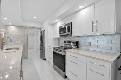 Discover luxury living in this beautifully renovated condo at on Boca West Golf and Country Club in Florida - for sale on GolfHomes.com, golf home, golf lot