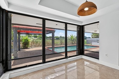 Stunning 4BR/2BA waterfront pool home in prestigious Country on  in Florida - for sale on GolfHomes.com, golf home, golf lot