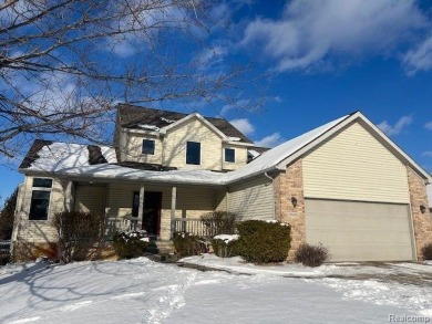 This home's  covered front porch and two story entryway welcomes on Fenton Farms Golf Club in Michigan - for sale on GolfHomes.com, golf home, golf lot