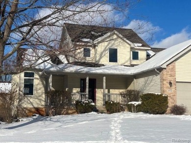 This home's  covered front porch and two story entryway welcomes on Fenton Farms Golf Club in Michigan - for sale on GolfHomes.com, golf home, golf lot