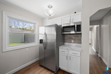 Cute as a button! This quaint one-level home is sure to impress on Elmwood Park Golf Course in South Dakota - for sale on GolfHomes.com, golf home, golf lot