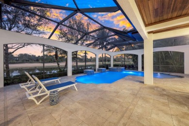 Escape to tranquility overlooking water and panoramic golf on The Golf Club At Fiddlers Creek in Florida - for sale on GolfHomes.com, golf home, golf lot