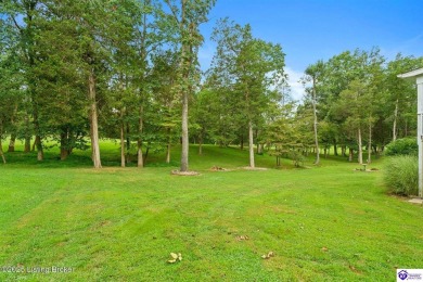 Experience tranquility and comfort in Brandenburg's premier on Doe Valley Country Club in Kentucky - for sale on GolfHomes.com, golf home, golf lot
