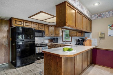 This one's been loved and it shows. Solid all brick home with on Horton Smith Golf Course in Missouri - for sale on GolfHomes.com, golf home, golf lot