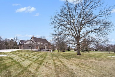 This completely updated Colonial overlooking the #12 Green at on Travis Pointe Country Club in Michigan - for sale on GolfHomes.com, golf home, golf lot
