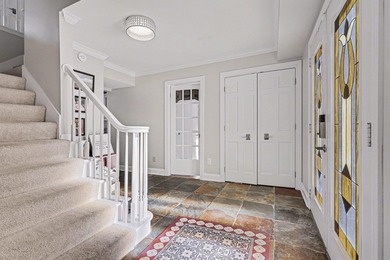 This completely updated Colonial overlooking the #12 Green at on Travis Pointe Country Club in Michigan - for sale on GolfHomes.com, golf home, golf lot