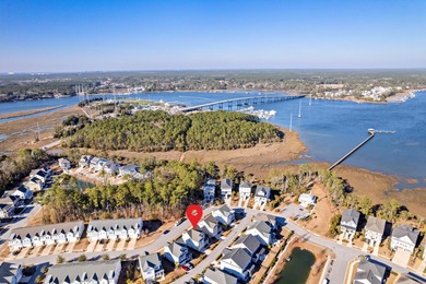 Welcome home to this light-filled coastal retreat tucked inside on Dunes West Golf Club in South Carolina - for sale on GolfHomes.com, golf home, golf lot