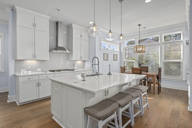 Welcome home to this light-filled coastal retreat tucked inside on Dunes West Golf Club in South Carolina - for sale on GolfHomes.com, golf home, golf lot