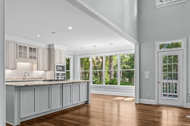 Enjoy sweeping lake views and an exceptional location just steps on Great Waters Course At Reynolds Plantation in Georgia - for sale on GolfHomes.com, golf home, golf lot