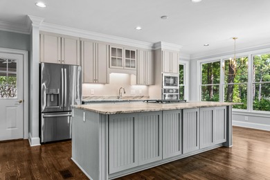 Enjoy sweeping lake views and an exceptional location just steps on Great Waters Course At Reynolds Plantation in Georgia - for sale on GolfHomes.com, golf home, golf lot