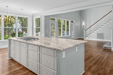 Enjoy sweeping lake views and an exceptional location just steps on Great Waters Course At Reynolds Plantation in Georgia - for sale on GolfHomes.com, golf home, golf lot