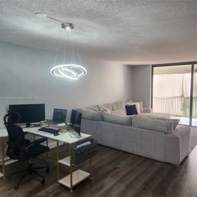 This spacious 2-bedroom condo features laminate wood flooring on Inverrary Country Club in Florida - for sale on GolfHomes.com, golf home, golf lot