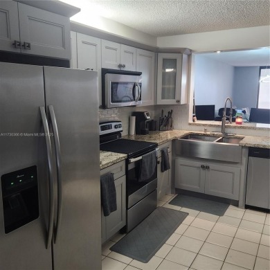 This spacious 2-bedroom condo features laminate wood flooring on Inverrary Country Club in Florida - for sale on GolfHomes.com, golf home, golf lot