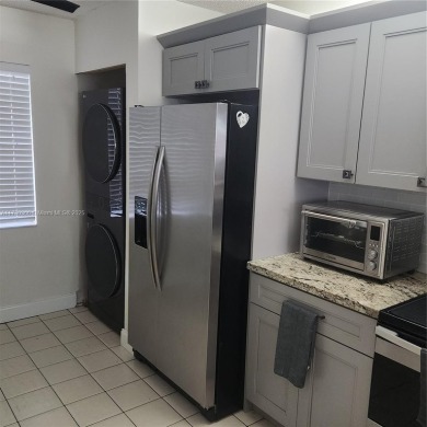 This spacious 2-bedroom condo features laminate wood flooring on Inverrary Country Club in Florida - for sale on GolfHomes.com, golf home, golf lot