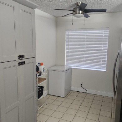 This spacious 2-bedroom condo features laminate wood flooring on Inverrary Country Club in Florida - for sale on GolfHomes.com, golf home, golf lot