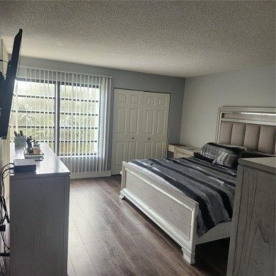 This spacious 2-bedroom condo features laminate wood flooring on Inverrary Country Club in Florida - for sale on GolfHomes.com, golf home, golf lot