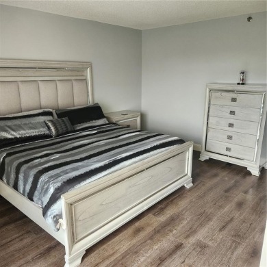 This spacious 2-bedroom condo features laminate wood flooring on Inverrary Country Club in Florida - for sale on GolfHomes.com, golf home, golf lot