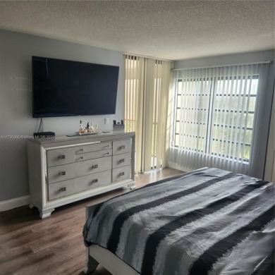 This spacious 2-bedroom condo features laminate wood flooring on Inverrary Country Club in Florida - for sale on GolfHomes.com, golf home, golf lot