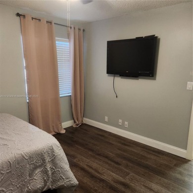 This spacious 2-bedroom condo features laminate wood flooring on Inverrary Country Club in Florida - for sale on GolfHomes.com, golf home, golf lot