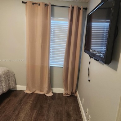 This spacious 2-bedroom condo features laminate wood flooring on Inverrary Country Club in Florida - for sale on GolfHomes.com, golf home, golf lot