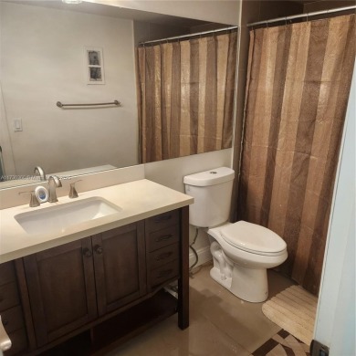 This spacious 2-bedroom condo features laminate wood flooring on Inverrary Country Club in Florida - for sale on GolfHomes.com, golf home, golf lot