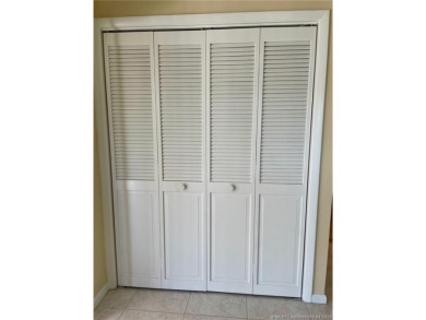 This 2/2 plus den with a 1 car garage is set on a peaceful lake on Martin Downs Country Club in Florida - for sale on GolfHomes.com, golf home, golf lot