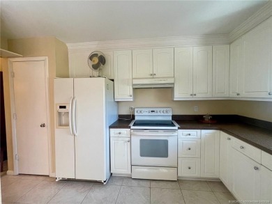 This 2/2 plus den with a 1 car garage is set on a peaceful lake on Martin Downs Country Club in Florida - for sale on GolfHomes.com, golf home, golf lot