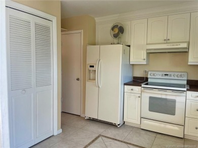 This 2/2 plus den with a 1 car garage is set on a peaceful lake on Martin Downs Country Club in Florida - for sale on GolfHomes.com, golf home, golf lot