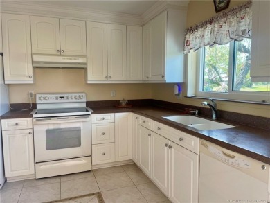 This 2/2 plus den with a 1 car garage is set on a peaceful lake on Martin Downs Country Club in Florida - for sale on GolfHomes.com, golf home, golf lot