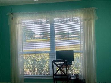 This 2/2 plus den with a 1 car garage is set on a peaceful lake on Martin Downs Country Club in Florida - for sale on GolfHomes.com, golf home, golf lot