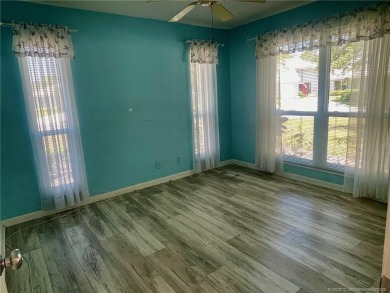 This 2/2 plus den with a 1 car garage is set on a peaceful lake on Martin Downs Country Club in Florida - for sale on GolfHomes.com, golf home, golf lot