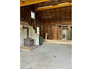 Two bedroom bungalow between Duck Lake and White Lake on a wide on Highland Hills Golf Course in Michigan - for sale on GolfHomes.com, golf home, golf lot
