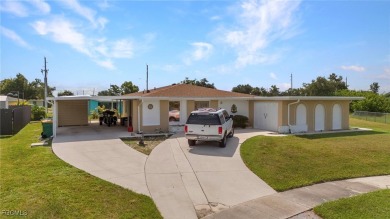 CHARMING MID-CENTURY HOME IN A QUIET CUL-DE-SAC WITH WATER VIEWS on Port Charlotte Golf Club in Florida - for sale on GolfHomes.com, golf home, golf lot