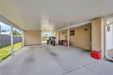CHARMING MID-CENTURY HOME IN A QUIET CUL-DE-SAC WITH WATER VIEWS on Port Charlotte Golf Club in Florida - for sale on GolfHomes.com, golf home, golf lot