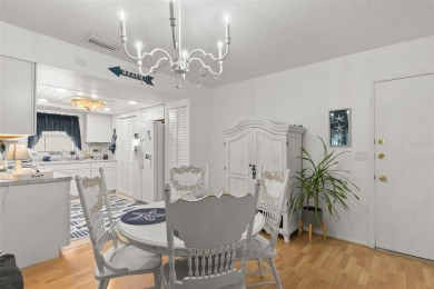 WELCOME TO THE GREEN DOLPHIN! This beautifully updated end-unit on Tarpon Springs Golf Course in Florida - for sale on GolfHomes.com, golf home, golf lot