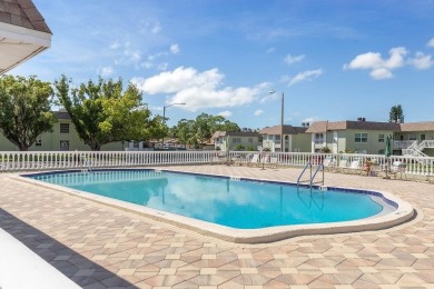 WELCOME TO THE GREEN DOLPHIN! This beautifully updated end-unit on Tarpon Springs Golf Course in Florida - for sale on GolfHomes.com, golf home, golf lot