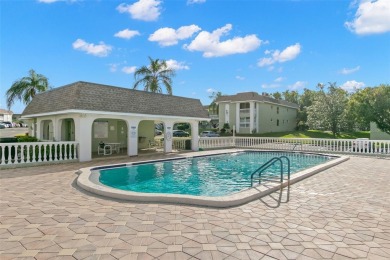 WELCOME TO THE GREEN DOLPHIN! This beautifully updated end-unit on Tarpon Springs Golf Course in Florida - for sale on GolfHomes.com, golf home, golf lot