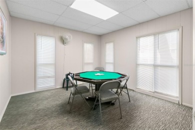 WELCOME TO THE GREEN DOLPHIN! This beautifully updated end-unit on Tarpon Springs Golf Course in Florida - for sale on GolfHomes.com, golf home, golf lot