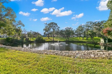 WELCOME TO THE GREEN DOLPHIN! This beautifully updated end-unit on Tarpon Springs Golf Course in Florida - for sale on GolfHomes.com, golf home, golf lot