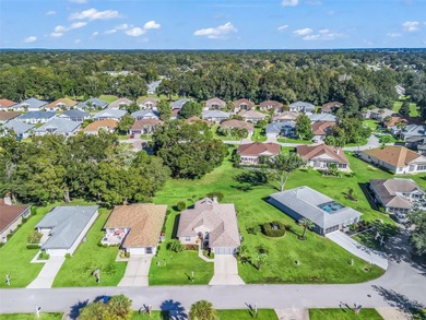 This beautifully maintained concrete block and stucco 'Doral' on Royal Oaks Golf Club in Florida - for sale on GolfHomes.com, golf home, golf lot
