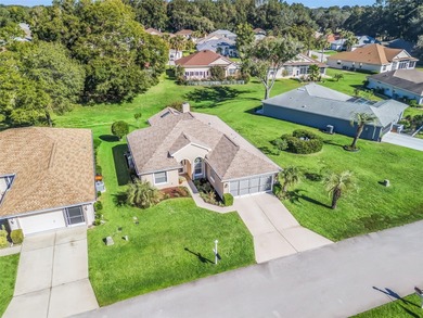 This beautifully maintained concrete block and stucco 'Doral' on Royal Oaks Golf Club in Florida - for sale on GolfHomes.com, golf home, golf lot