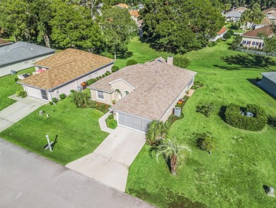 This beautifully maintained concrete block and stucco 'Doral' on Royal Oaks Golf Club in Florida - for sale on GolfHomes.com, golf home, golf lot