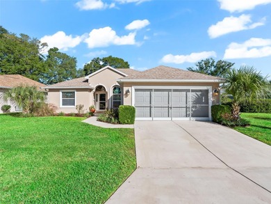 This beautifully maintained concrete block and stucco 'Doral' on Royal Oaks Golf Club in Florida - for sale on GolfHomes.com, golf home, golf lot