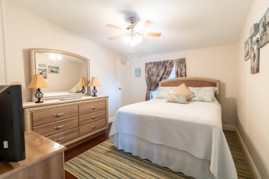 Nestled within the welcoming embrace of Whispering Pines in on Lily Lake Golf and RV Resort in Florida - for sale on GolfHomes.com, golf home, golf lot