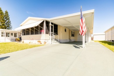 Nestled within the welcoming embrace of Whispering Pines in on Lily Lake Golf and RV Resort in Florida - for sale on GolfHomes.com, golf home, golf lot