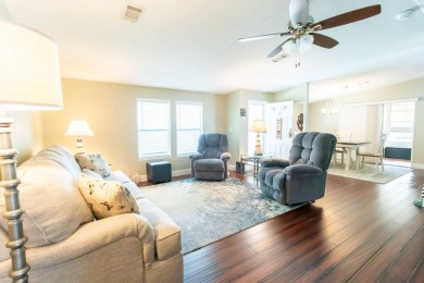 Nestled within the welcoming embrace of Whispering Pines in on Lily Lake Golf and RV Resort in Florida - for sale on GolfHomes.com, golf home, golf lot