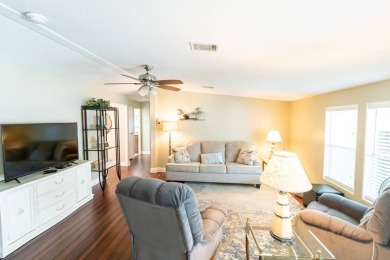 Nestled within the welcoming embrace of Whispering Pines in on Lily Lake Golf and RV Resort in Florida - for sale on GolfHomes.com, golf home, golf lot